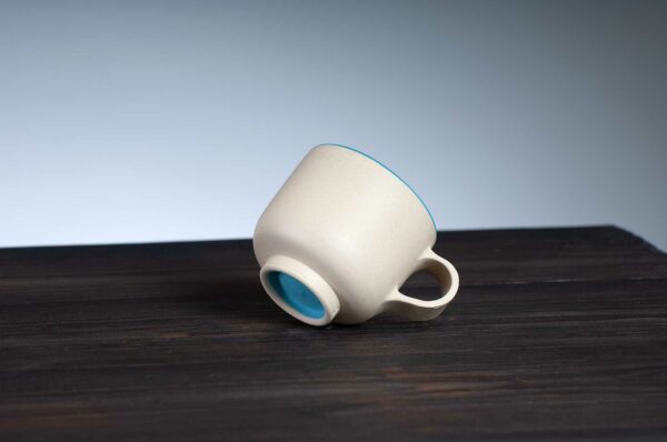 bottom view of espresso cup with blue rim