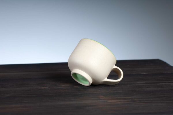 bottom view of espresso cup with green rim