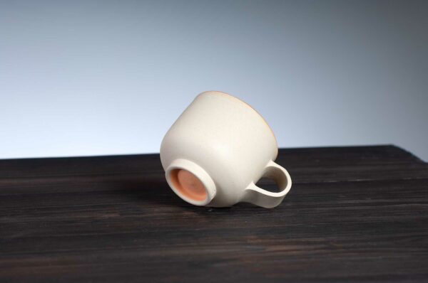 bottom view of espresso cup with orange rim