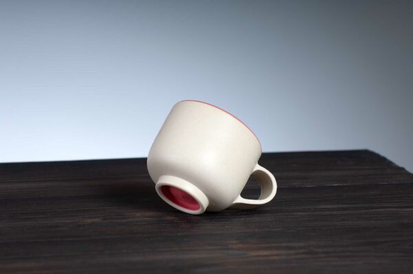 bottom view of espresso cup with red rim