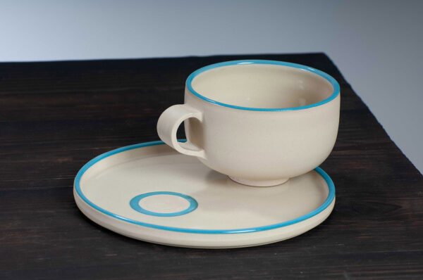 top view of cappuccino cup and saucer set with blue rim