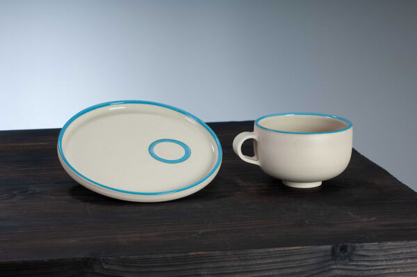 cappuccino cup and saucer set with blue rim side by side