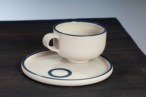 top view of cappuccino cup and saucer set with navy rim