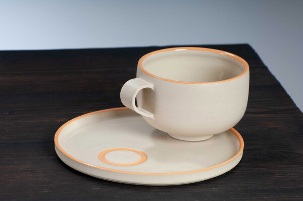 top view of cappuccino cup and saucer set with orange rim