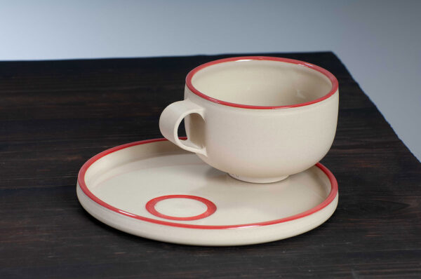 top view of cappuccino cup and saucer with red rim