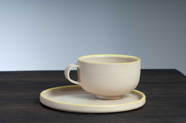 front view of cappuccino cup and saucer with yellow rim