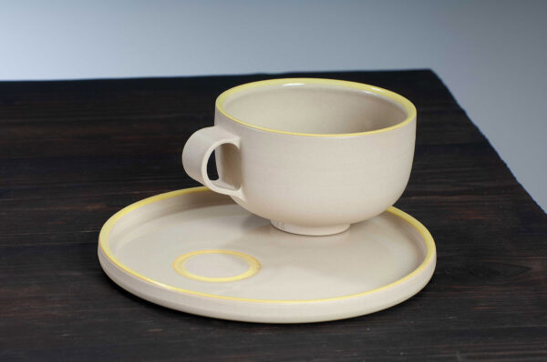 top view of cappuccino cup and saucer with yellow rim