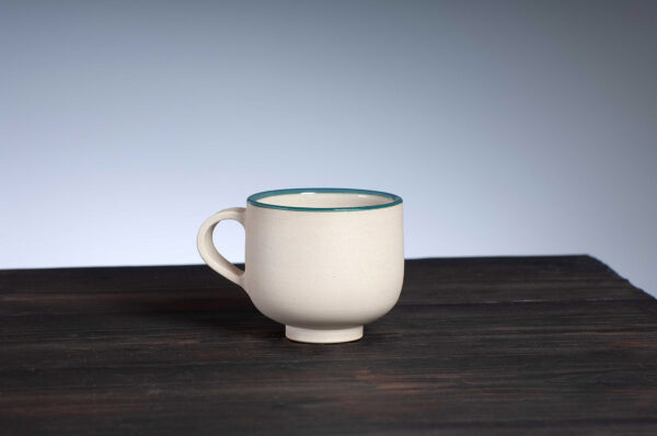 front view of coffee cup with teal rim