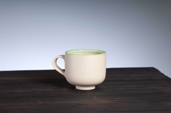 front view of coffee cup with green rim