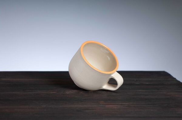 top view of coffee cup with orange rim