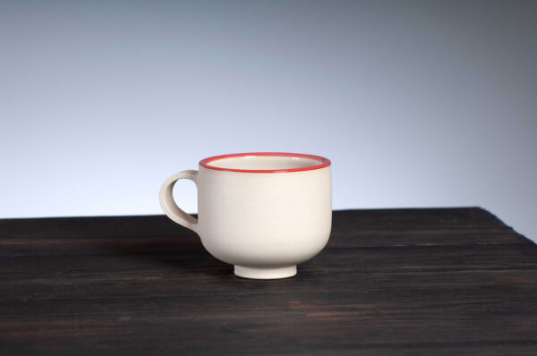 front view of coffee cup with red rim