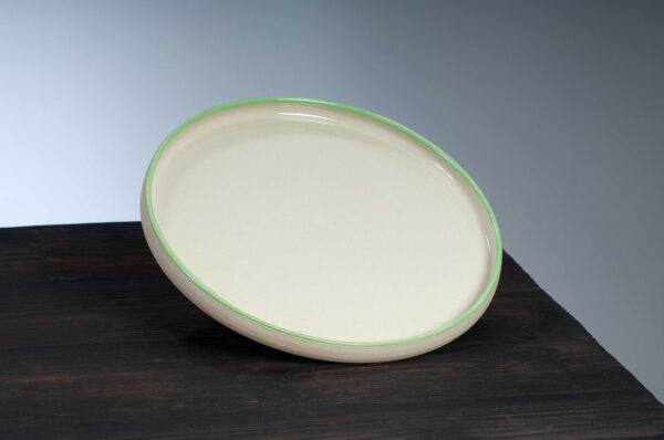 top view of dinner plate with green rim