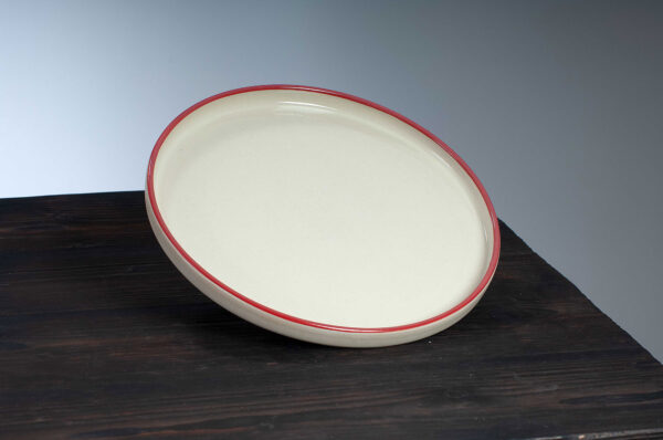 top view of dinner plate with red rim