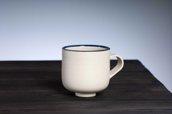 front view of stoneware mug with navy rim