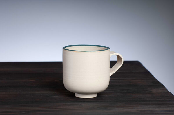 front view of stoneware mug with teal rim