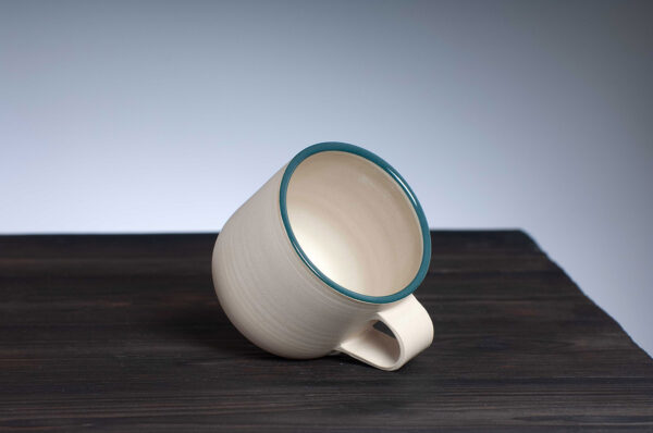 top view of stoneware mug with teal rim