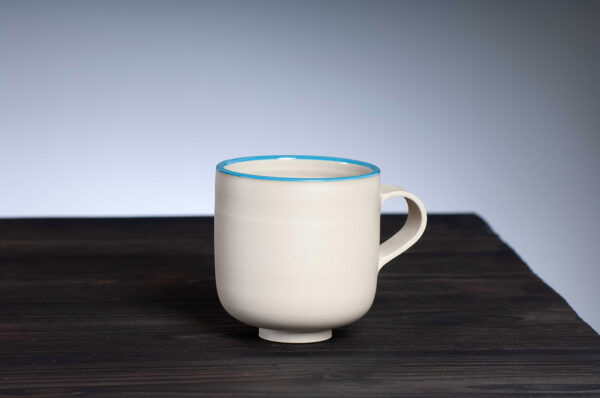 front view of stoneware mug with blue rim