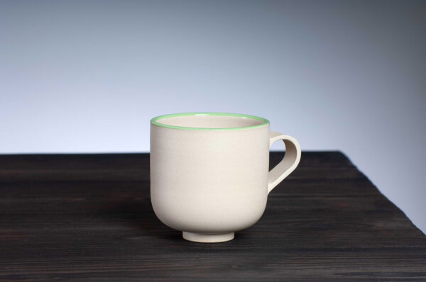 front view of stoneware mug with green rim