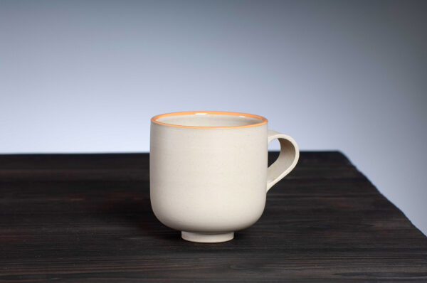 front view of stoneware mug with orange rim