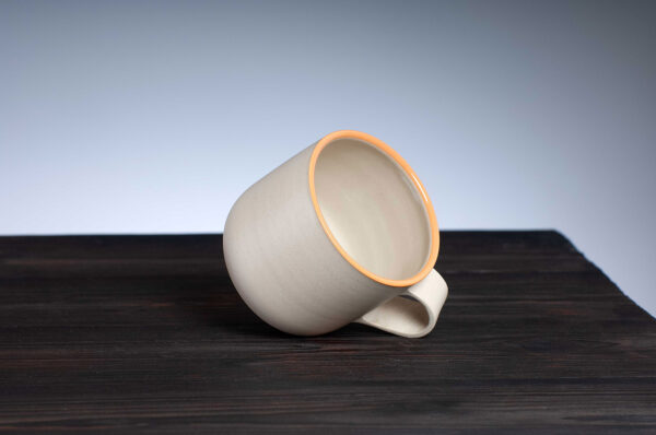 top view of stoneware mug with orange rim