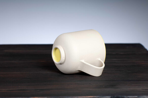 bottom view of stoneware mug with yellow rim